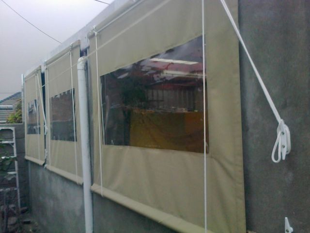 Three beige PVC outdoor blinds with windows