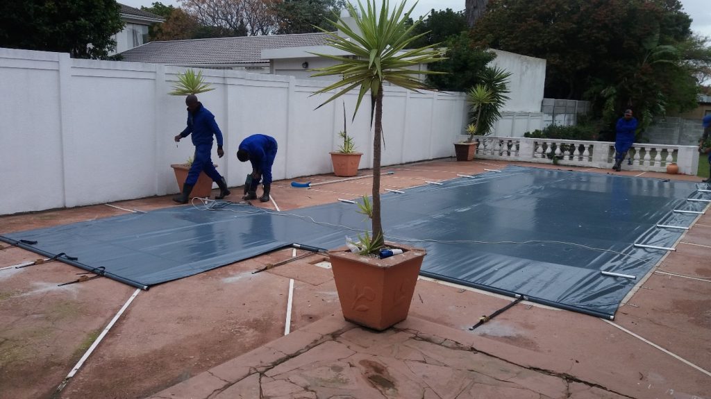 Gray pool cover over pool